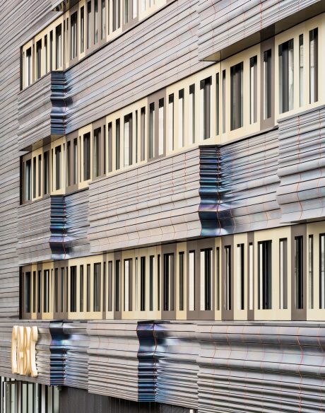 Reconversion and extension, including the premises of the GRED in a unique building which associates with the spaces of research for the premises of education (teaching), amphitheaters, a tree nursery of company and common premises. Differents elements of terracotta enamelled black iridescent are combined. CRBC, 26 place Henri Dunant 63000 CLERMONT FERRAND. Panels Argeton Double Peau Pétrole. 